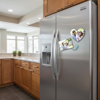 Heart-shaped fridge magnet with a family photo and another family photo below on a fridge 